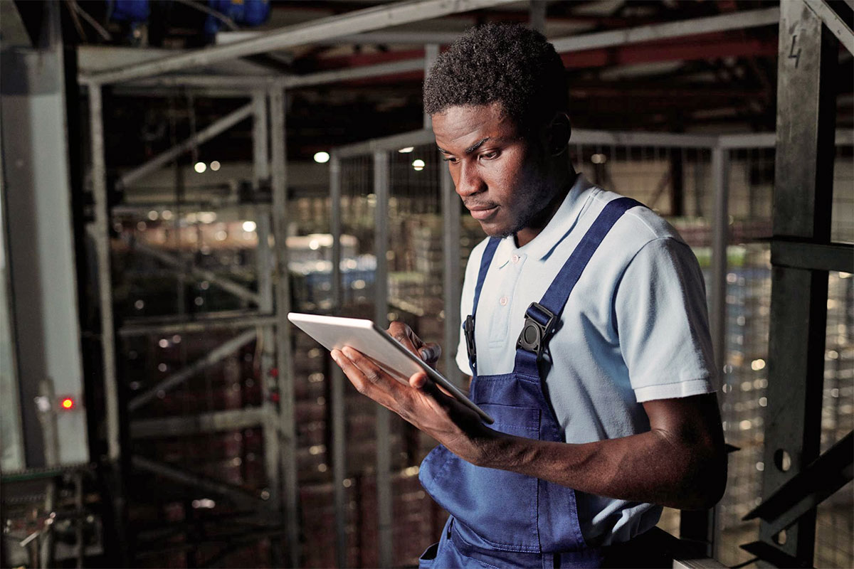 Frontline worker using employee communication hub CommsKit CONNECT on a mobile device