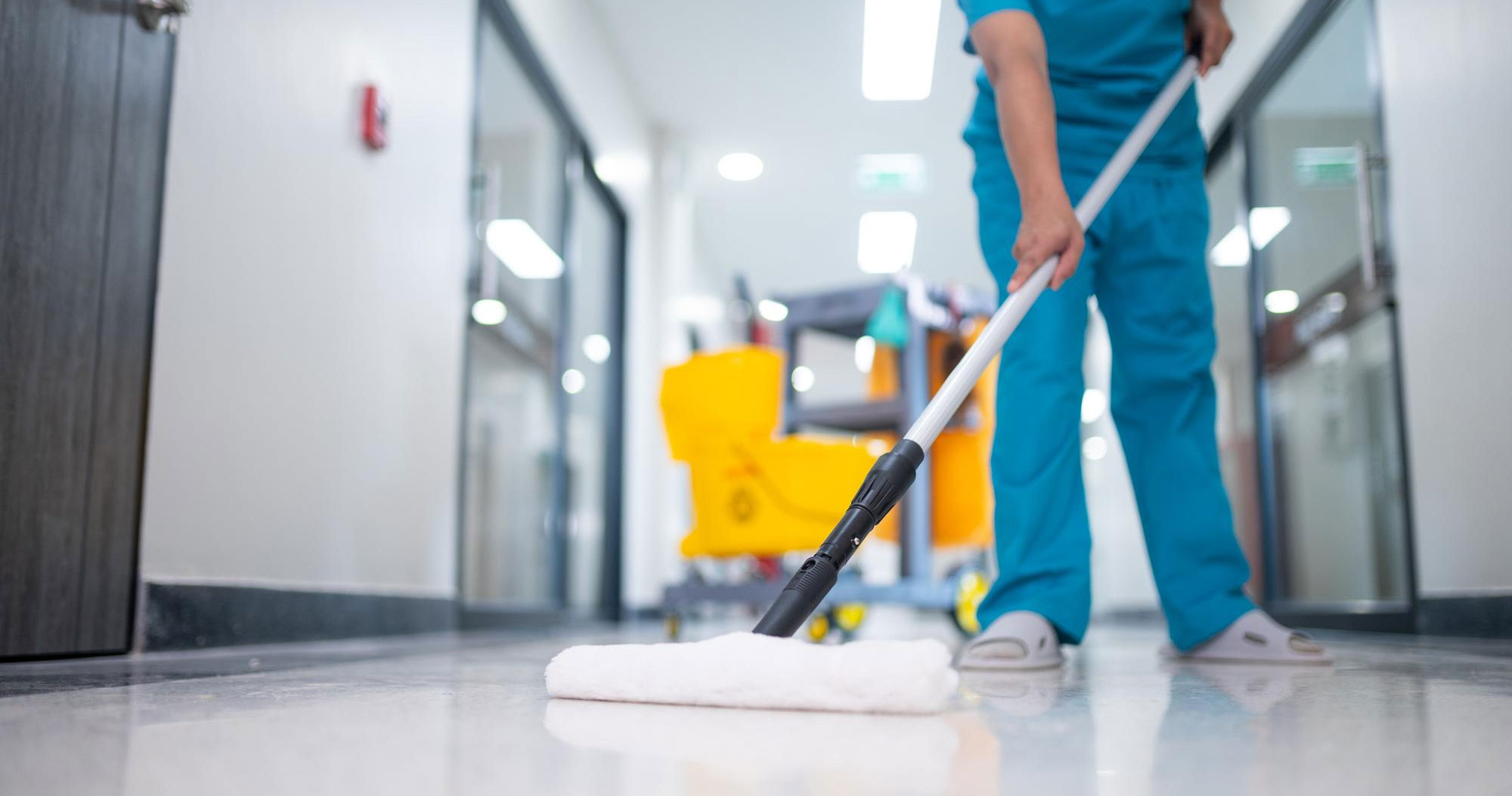 Public healthcare sector with CommsKit showing a worker cleaning the floor