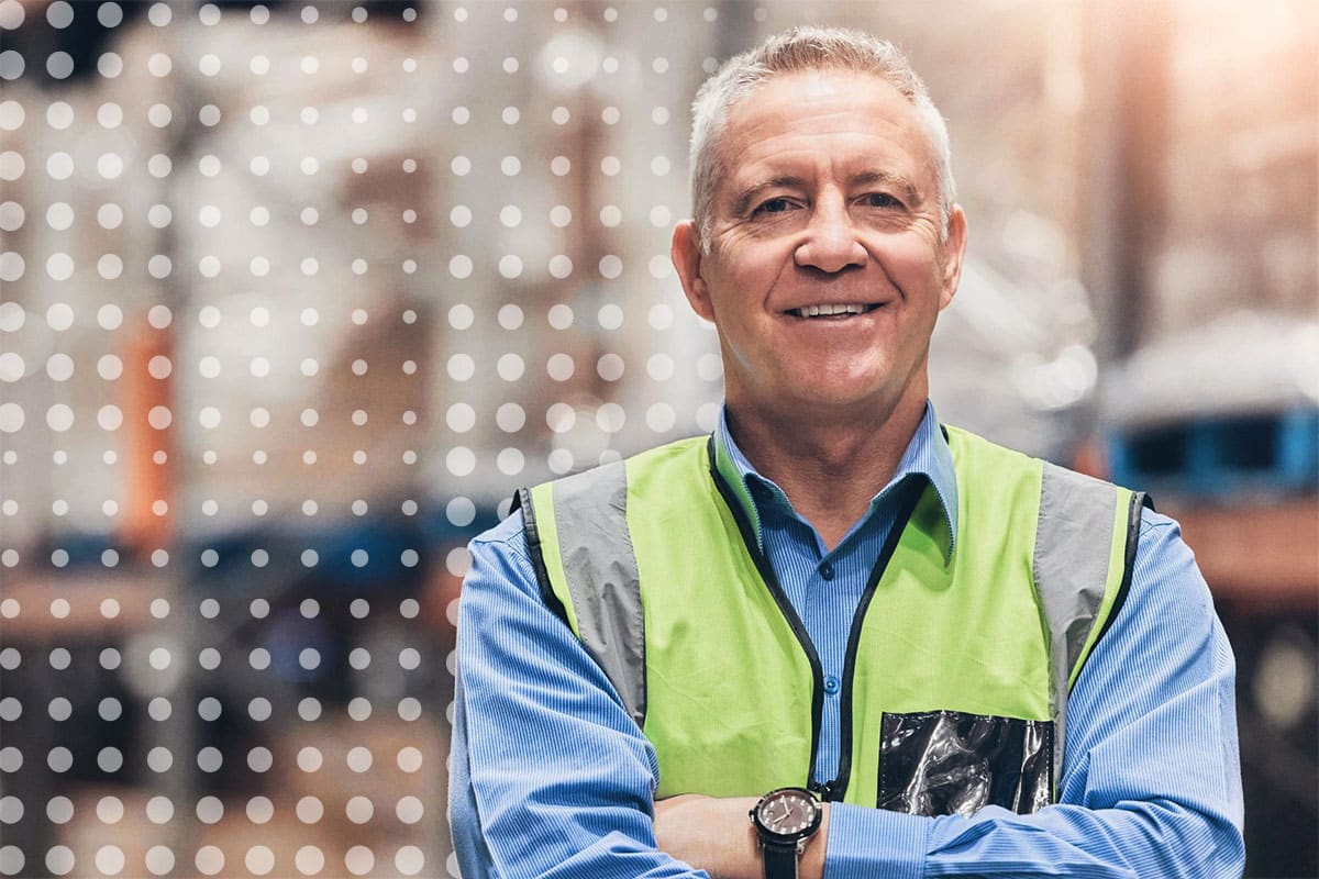 Older frontline worker at a logistics warehouse representing employee engagement with CommsKit