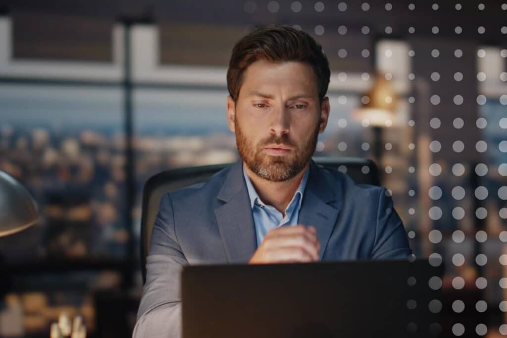 a businessman looking pensively at his article about AI discernment in business communications