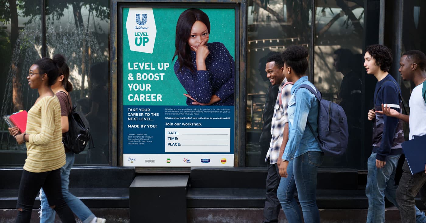 employer-branding-poster-design-unilever-commskit Employer branding for large workforces: a Unilever graduate recruitment poster displayed on a wall as graduates walk past